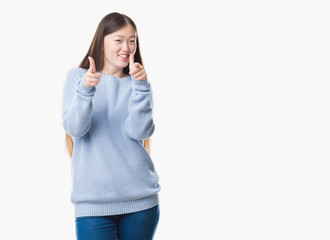 Young Chinese woman over isolated background pointing fingers to camera with happy and funny face. Good energy and vibes.