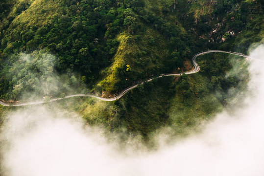 Mountain road. Tea plantation. The road from the quadcopter. Winding road in the mountains. Mountains in clouds. Landscapes of Sri Lanka. Mountains covered with vegetation. Aerial photography