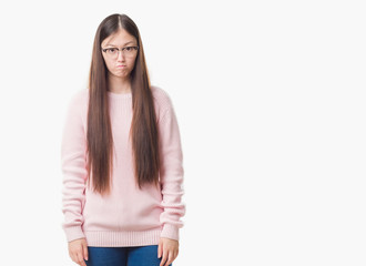 Young Chinese woman over isolated background wearing glasses depressed and worry for distress, crying angry and afraid. Sad expression.