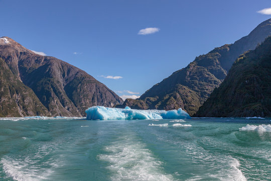 Iceberg from Sawyer glacier in front of boat in Tracy Arm fjord near Juneau Alaska