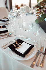 Sparkling glassware stands on table prepared for wedding. Wedding decor, interior. Festive. Banquet table.