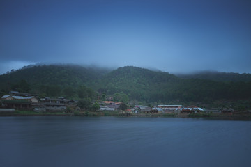 village  beside the water with full of fog is bad weather.