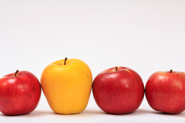 Row of ripe apples on a white background