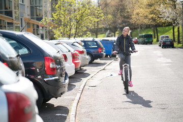 woman commuting on bicycle and looking at camera