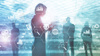 Double exposure mixed media. Diagrams and icons on hologram screen. Business people and modern city on background.