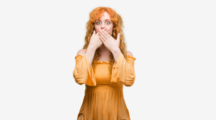 Young redhead woman shocked covering mouth with hands for mistake. Secret concept.