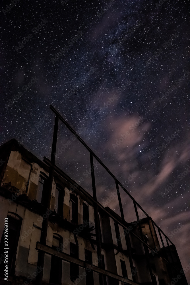Wall mural night sky and the milky way over the old abandoned house