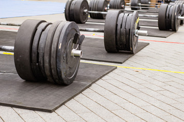 Fototapeta premium weight lifting equipment, outdoors powerlifting competition, closeups with athletic equipment 