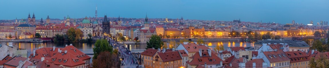 Prague - The panorama of the city with the Charles bridge on Olt Town at dusk.