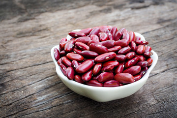 Red bean kidney in white bowl on old wooden background