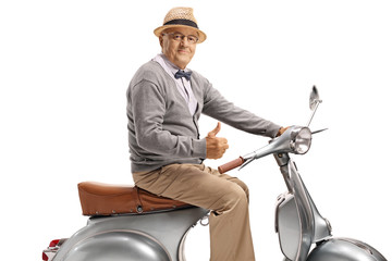 Senior man sitting on a vintage scooter and showing thumbs up