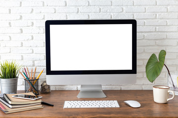Fototapeta premium workspace with computer with blank white screen, and office supplies on a wooden desk