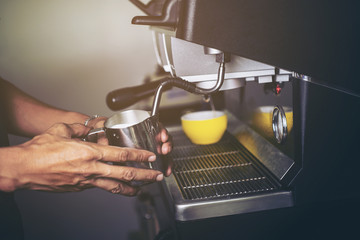Barista making  fresh espresso with a classic Italian coffee machine with steam in background. barista Coffee Maker Machine Grinder Portafilter Concept