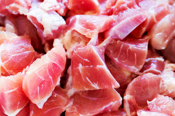 Fresh pork is cut into pieces.