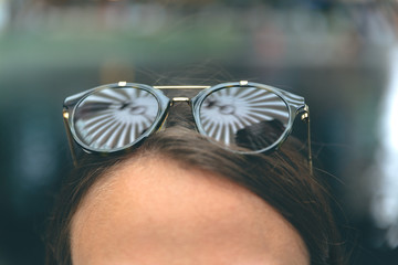 Modern sunglasses on top of a young woman's head