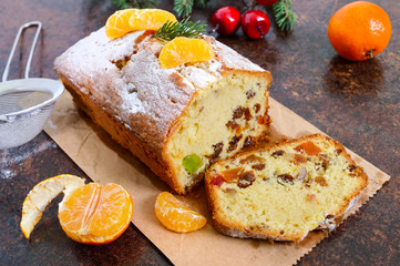 Christmas cake with nuts, dried fruit, tangerines. Traditional festive pastries.