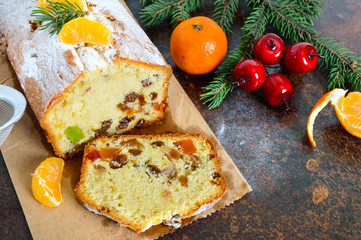 Christmas cake with nuts, dried fruit, tangerines. Traditional festive pastries.