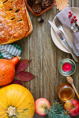 Delicious pie with cabbage and forest  mushrooms on a wooden background. The table is served in the autumn theme. The top view. Flat lay.