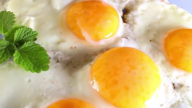 Fried egg eggs rotating texture pattern closeup footage