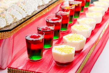 Tasty colorful jelly with cherries in glass dishes_