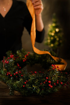Woman decorating holiday wreath