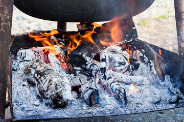 Fire at a boiler for cooking during a hiking trip_