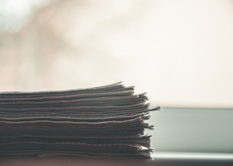 Stack of newspapers lying on the window