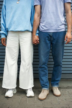Hipster couple's hand-holding and legs