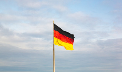 German flag waved by the wind in a sunny day.