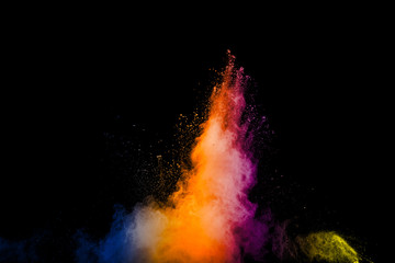 Abstract multi color powder explosion on black background.  Freeze motion of color dust  particles splash. Painted Holi in festival.