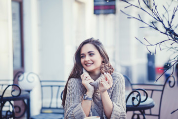 Trendy woman in autumn outfit chilling in cozy cafe, looking around