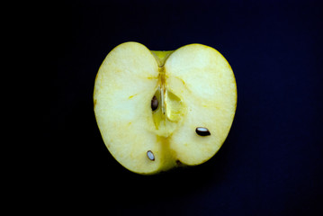 half homegrown organic apple on a black background