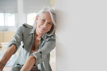  Beautiful relaxed elderly woman sitting at home