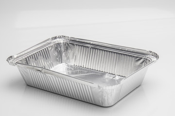 Foil food delivery container with reflection isolated over the white background