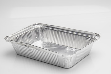 Foil food delivery container with reflection isolated over the white background