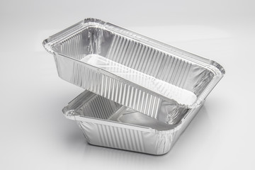 Foil food delivery container with reflection isolated over the white background