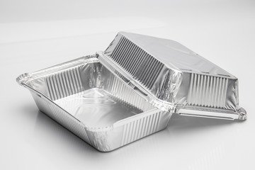 Foil food delivery container with reflection isolated over the white background