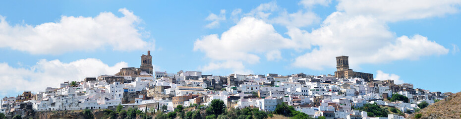 Fototapeta na wymiar Architectural complex consisting of white houses next to each other on top of a mountain