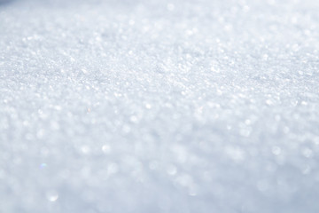 Snow crystals and snowflakes background close up macro white and blue in good view sparkling in the sun. Selective focus.Wallpaper. Poster