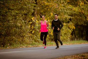 Young couple jogging together in park