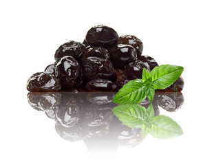 Black olives pile or heap isolated on white background