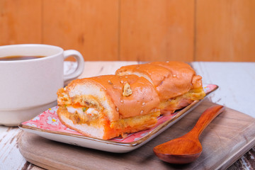 John bread and spoon   with a cup off coffee on wooden cutting board