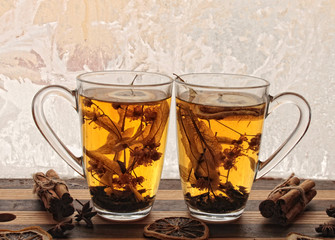 love / valentines day background with two cups of herbal tea against frozen window