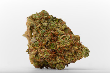 Close up of yumbolt strain hybrid indica dominant medical marijuana and recreational marijuana flower bud isolated in white background