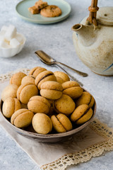 Baci di dama': delicious chocolate cookies with hazelnuts and topping on delicate background