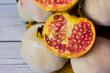Pomegranate fruit on a wooden plate