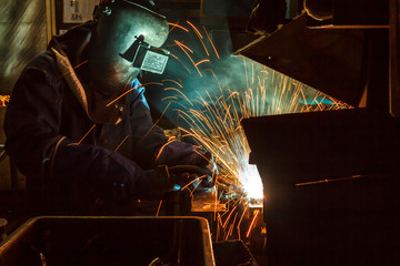 Industrial Worker at the factory welding