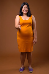 Obraz premium Beautiful overweight Asian woman smiling and giving handshake