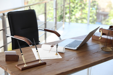 Vintage stamp, documents and laptop on desk in notary's office
