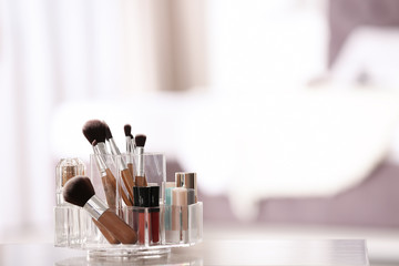Organizer with makeup cosmetic products on table indoors. Space for text